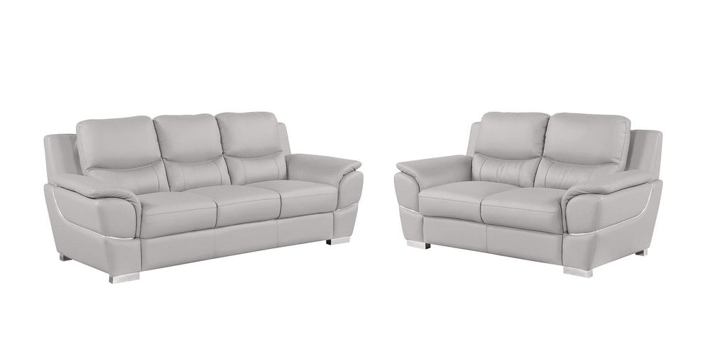 Two light gray leather sofas on a white background.