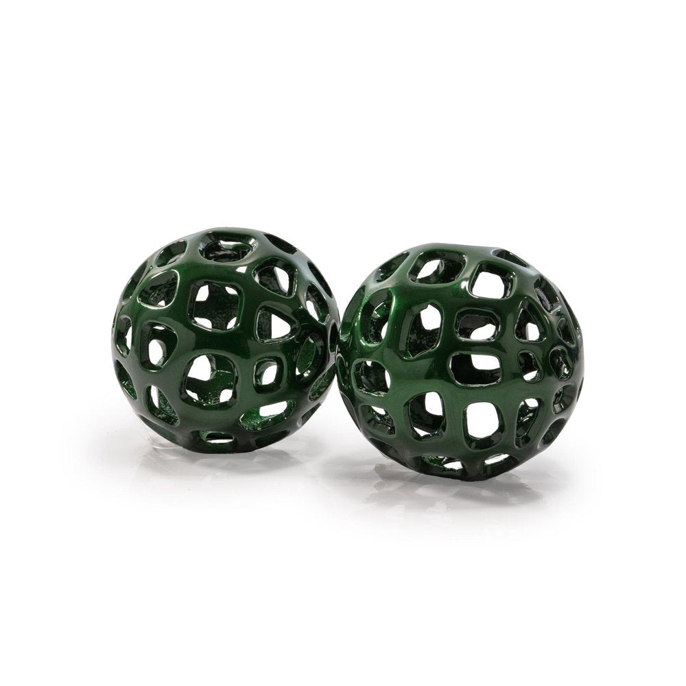 Two green, hollow, decorative orbs with a metallic finish on a white background.