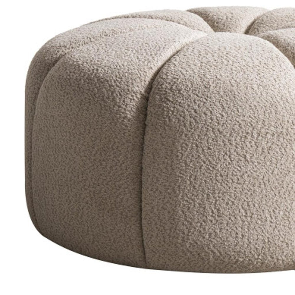 32" Taupe Tufted Boucle Tufted Round Ottoman. Ottoman isolated on a plain white background, showing its taupe color.