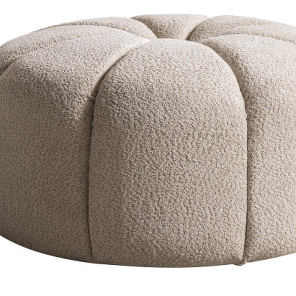 32" Taupe Tufted Boucle Tufted Round Ottoman. Ottoman isolated on a plain white background.