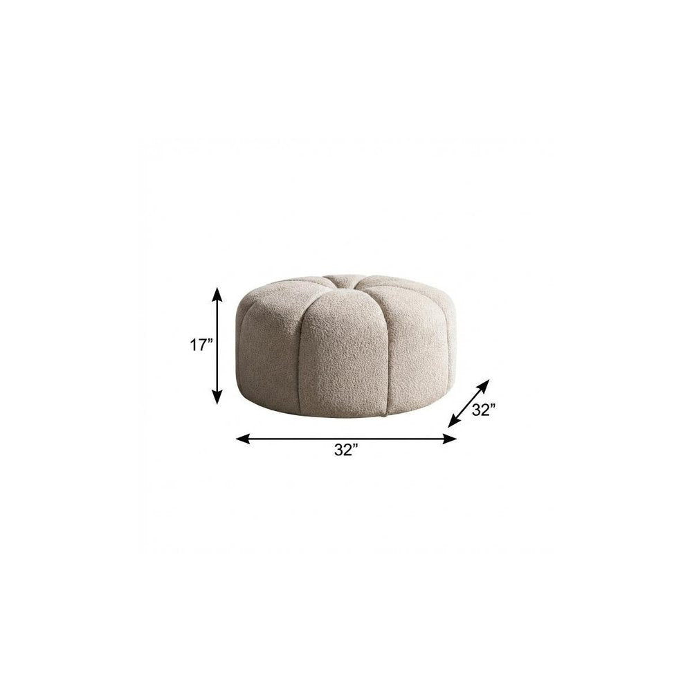 32" Taupe Tufted Boucle Tufted Round Ottoman. Ottoman isolated on a plain white background.