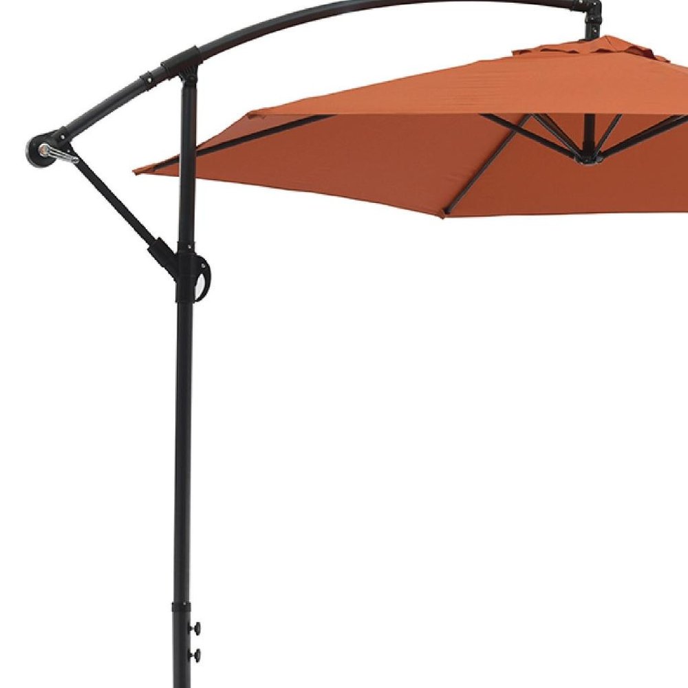9.5' Orange Polyester Hexagonal Cantilever Patio Umbrella with Stand on a white background
