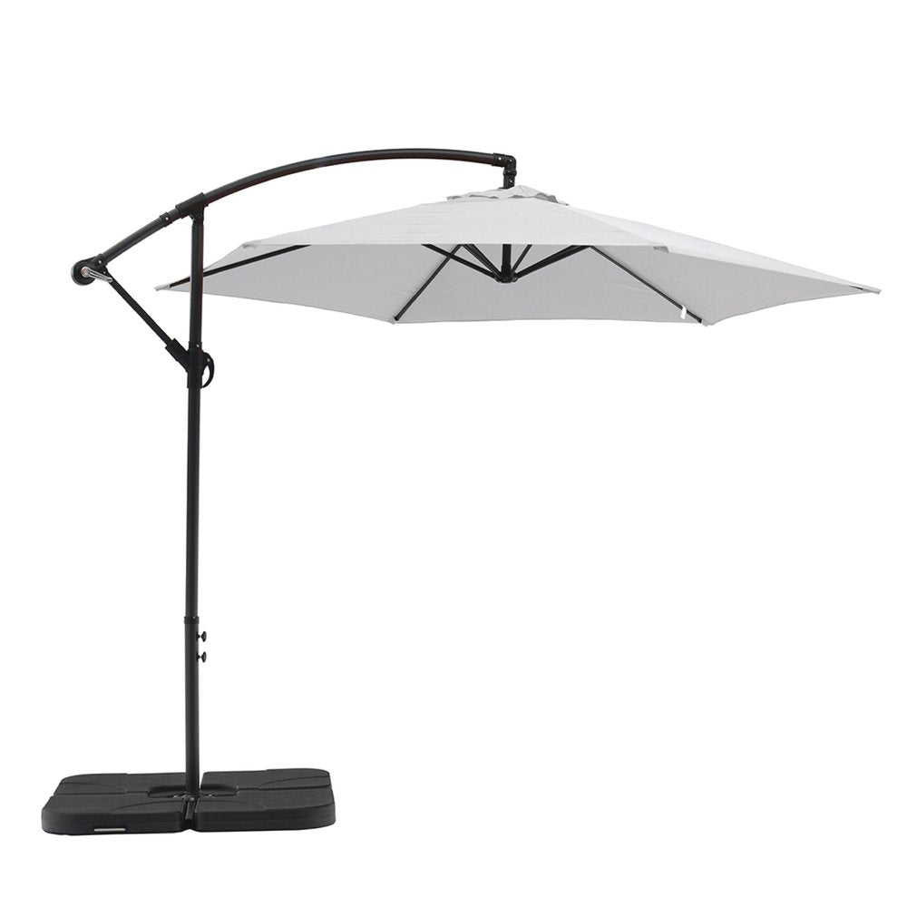 White hexagonal cantilever patio umbrella with a black pole and base on a white background.