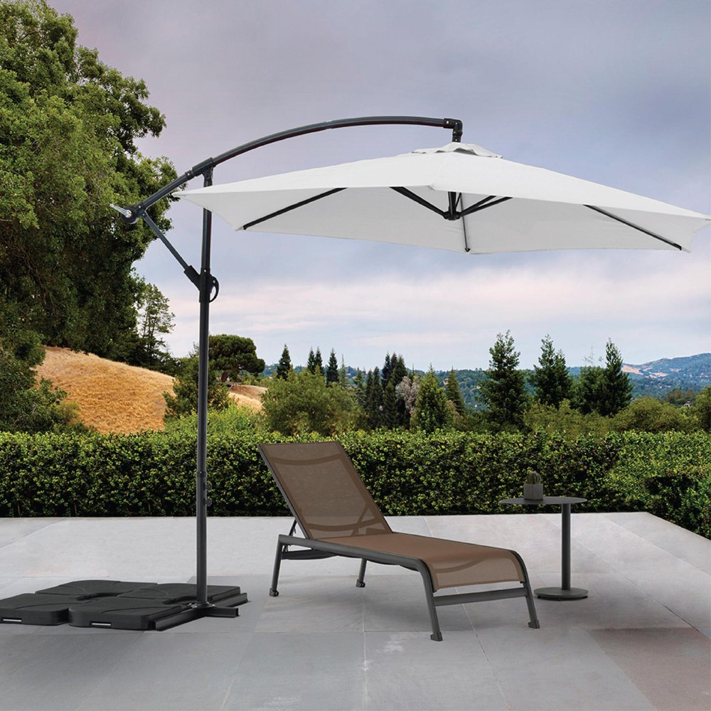 9.5' White Polyester Hexagonal Cantilever Patio Umbrella with Stand in a home interior