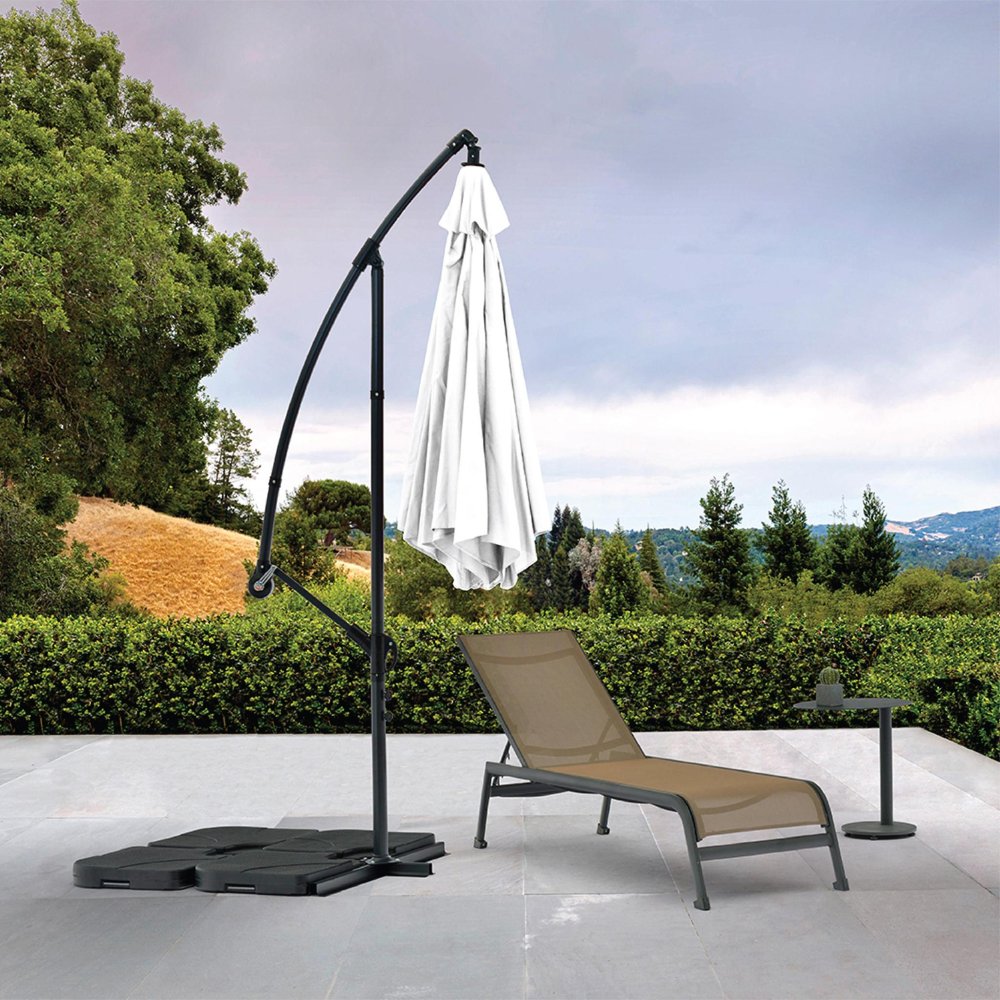 9.5' White Polyester Hexagonal Cantilever Patio Umbrella with Stand in a home interior
