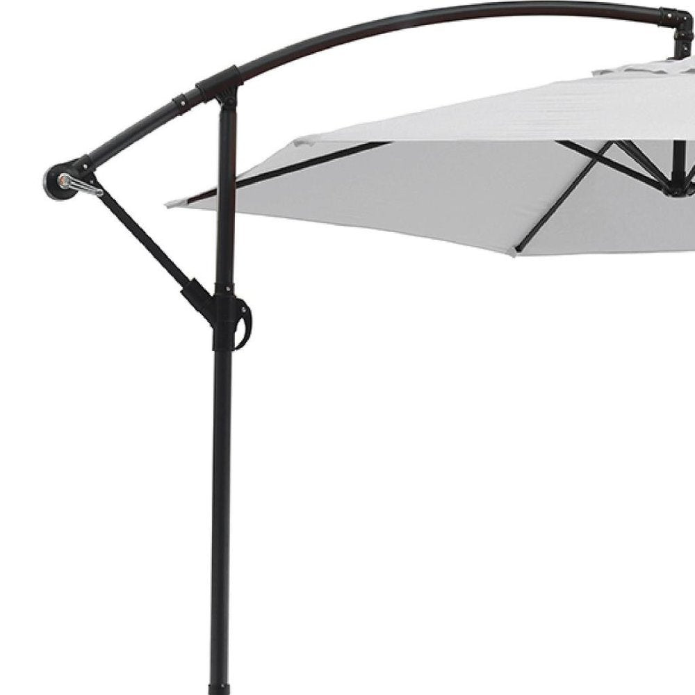 9.5' White Polyester Hexagonal Cantilever Patio Umbrella with Stand on a white background