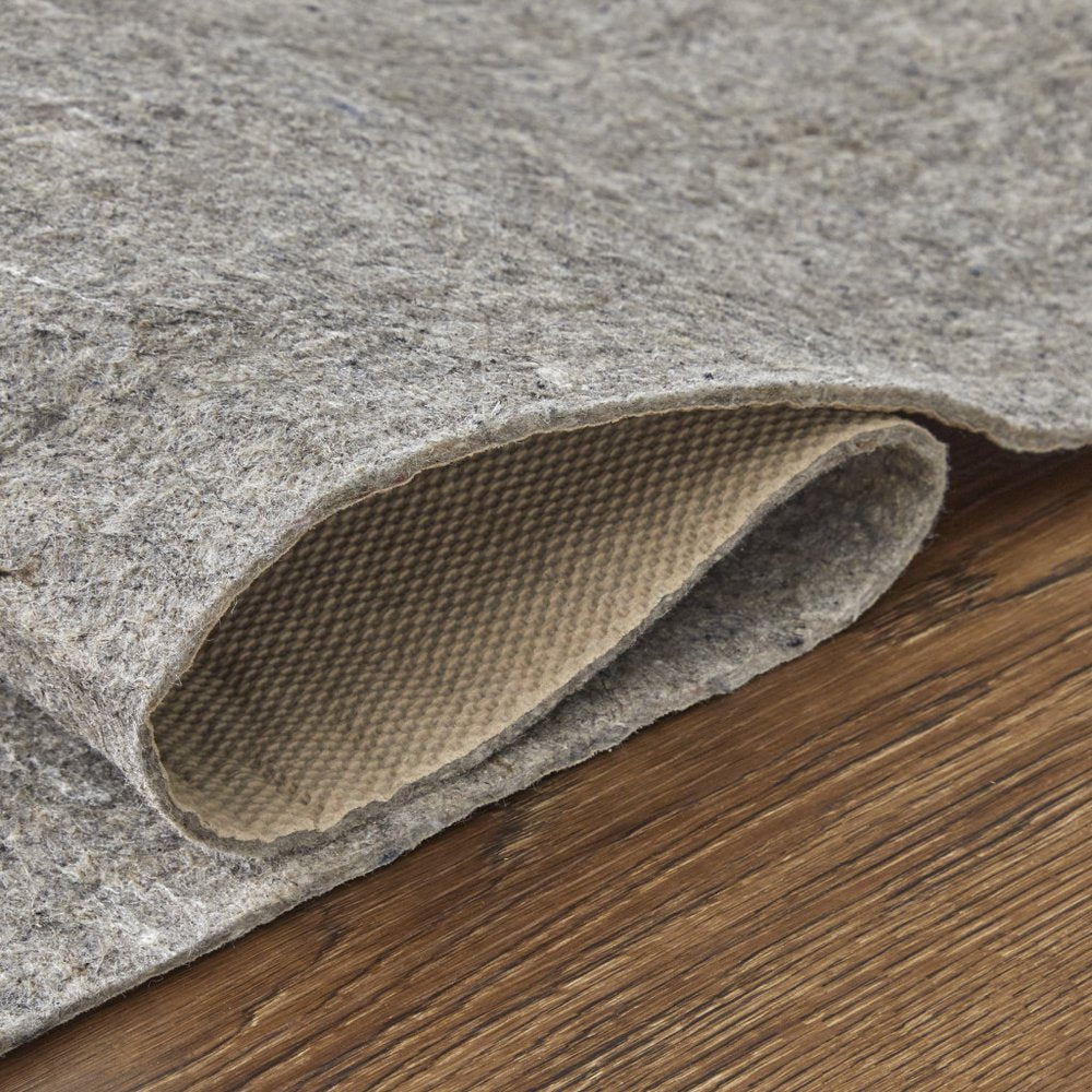 Gray non-slip rug pad with a textured backing, shown on a wooden floor.