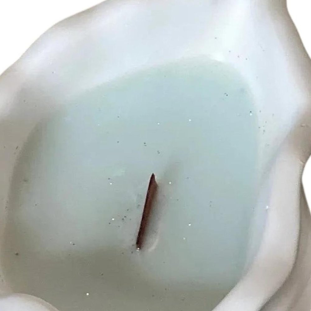 6" Light Blue Unscented Soy Wax Candle In White Resin Novelty Holder. Candle in white resin.