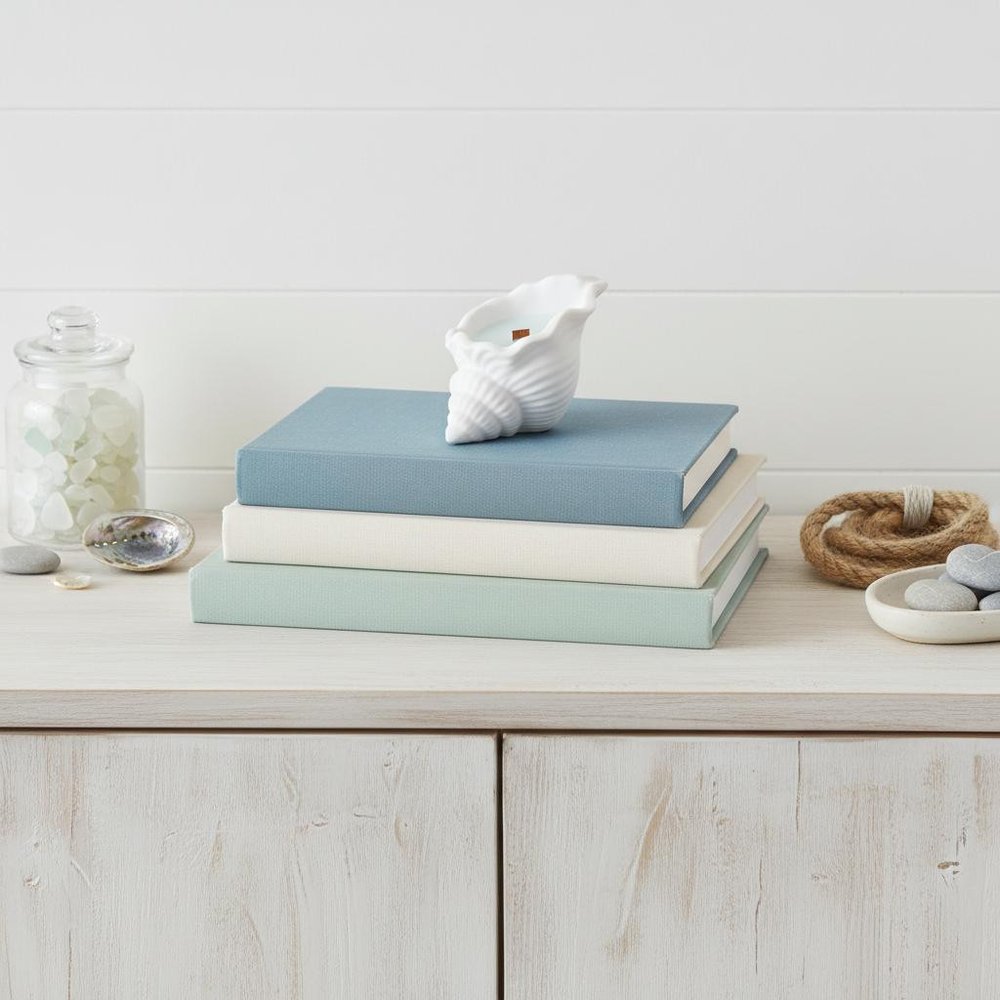 6" Light Blue High Tide Scented Soy Wax Candle In White Resin Novelty Holder. Candle isolated on a plain white background, showing a white resin surface.