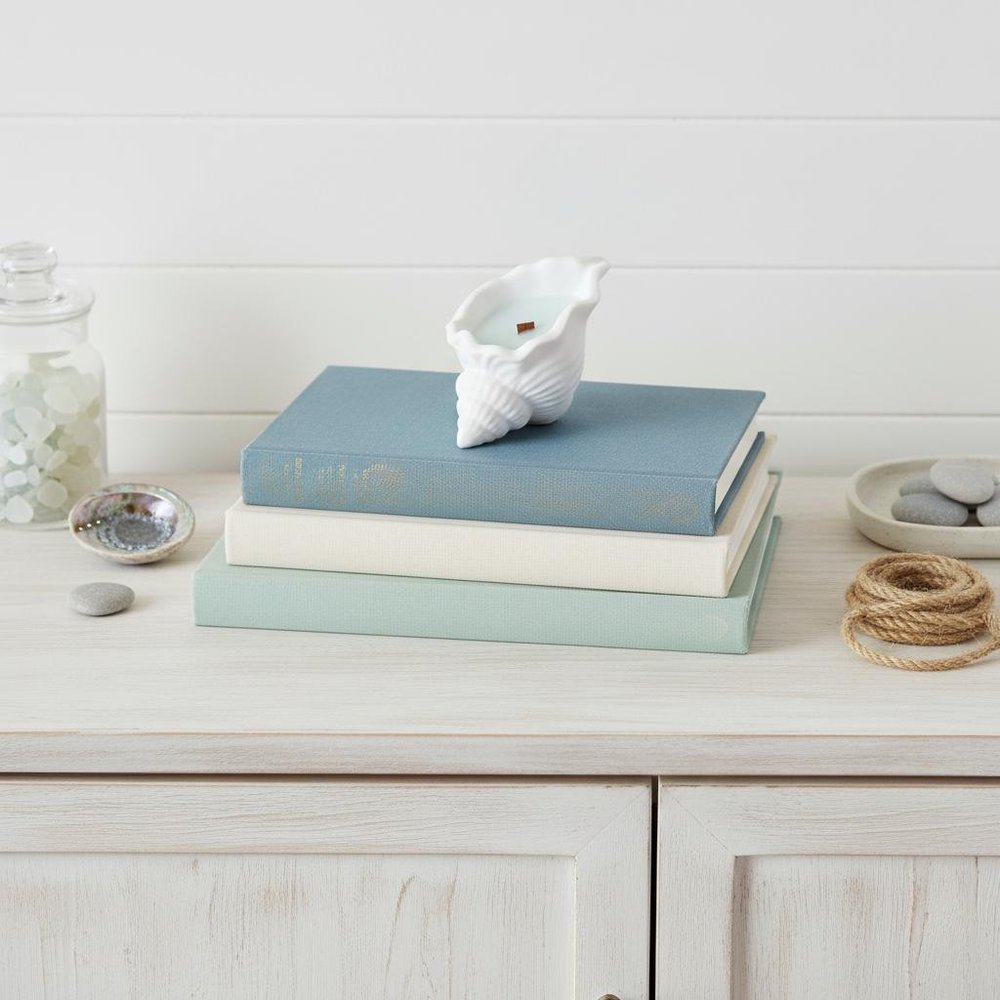 6" Light Blue High Tide Scented Soy Wax Candle In White Resin Novelty Holder. Candle isolated on a plain white background, finished in white resin.