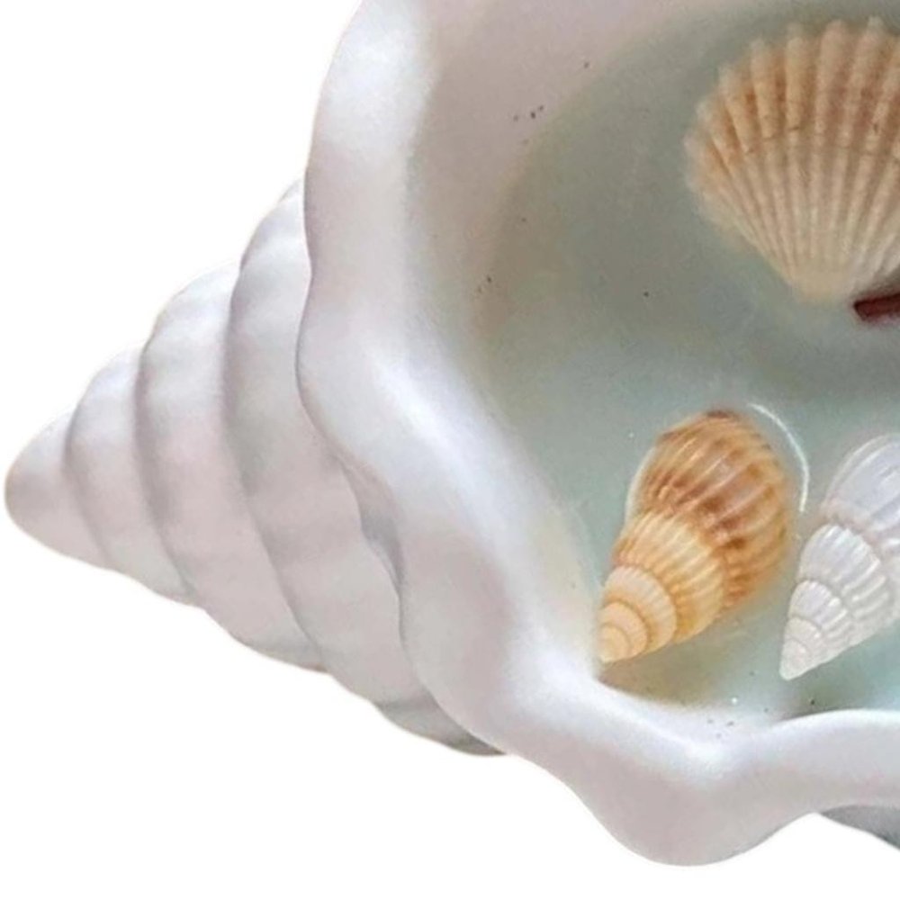 6" Light Blue Sea Salt And Orchid Scented Candle In White Resin Novelty Holder With Shells. Candle isolated on a plain white background, showing a resin surface.