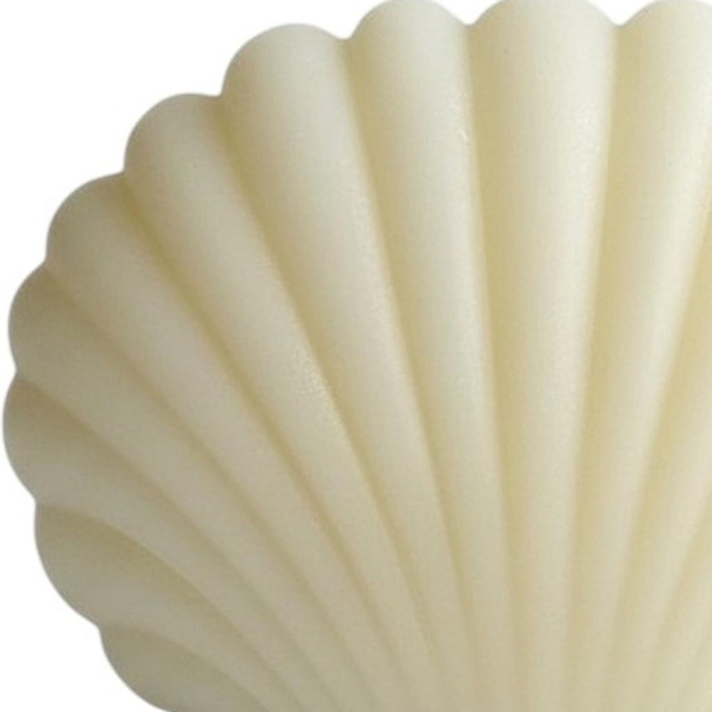 Close-up of 4" Ivory Black Ice Scented Dimensional Seashell Candle showing ivory detail.