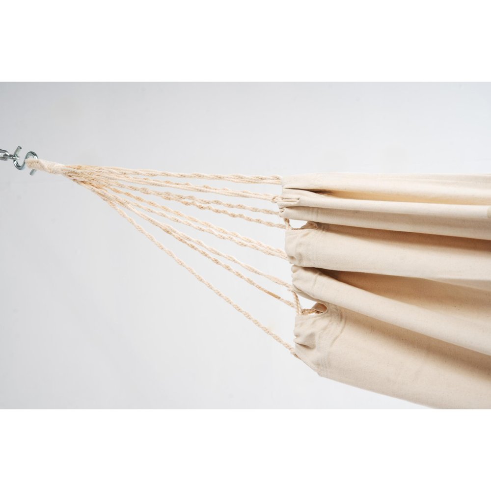 Close-up of an off-white canvas hammock with rope suspension attached to a metal hook against a white background.