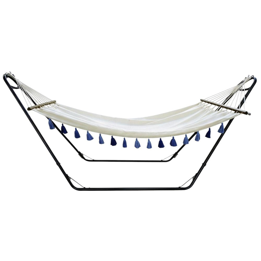 Ivory fabric hammock with blue tassels and a black metal stand against a white background.