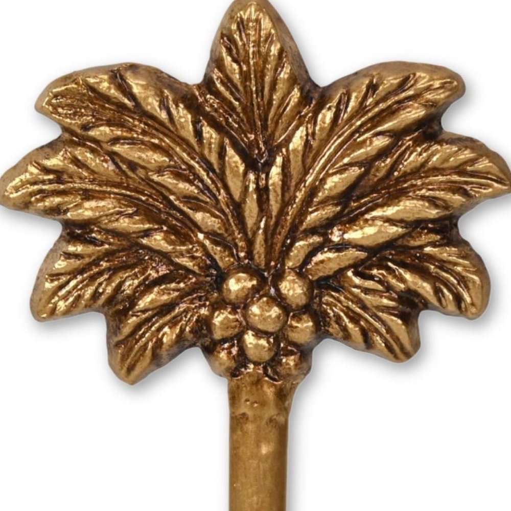 4" Antiqued Gold Cast Iron Palm Tree Wall Hook. Coat hanger isolated on a plain white background, finished in gold metal.