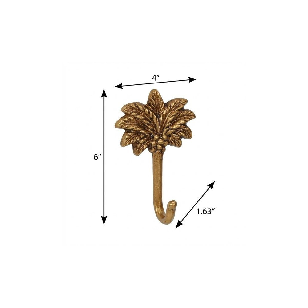 4" Antiqued Gold Cast Iron Palm Tree Wall Hook. Coat hanger isolated on a plain white background, in a gold metal finish.