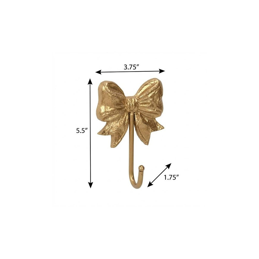 4" Gold Cast Iron Bow Wall Hook. Coat hanger isolated on a plain white background, showing a gold metal surface.