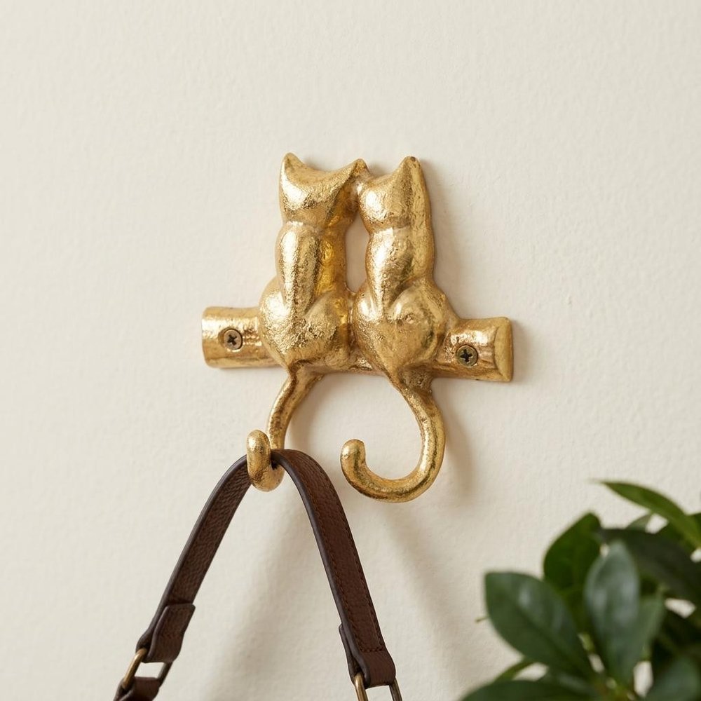 Two Hook 5" Gold Cast Iron Cats Wall Hooks in a home interior