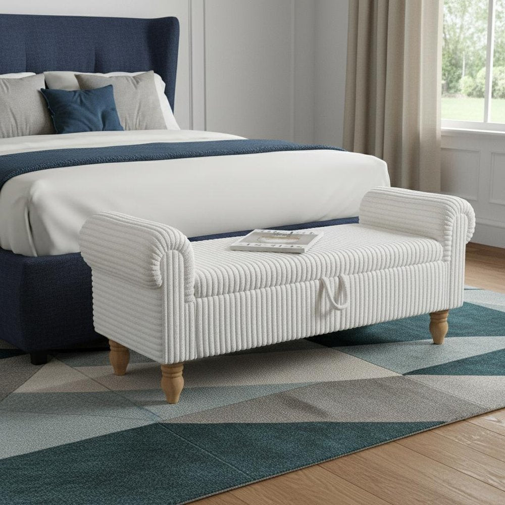 55" White and Brown Corduroy and Solid Wood Upholstered Storage Bench With Flip Top styled in a furnished interior with a gray wall on a charcoal floor.