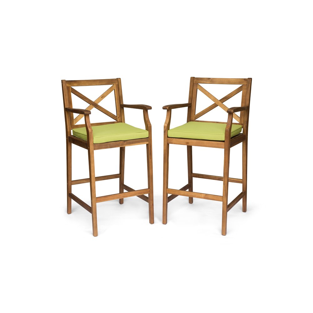 Two natural solid wood outdoor bar height chairs with green cushions on a white background.
