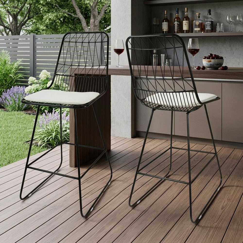 Set of Two 30" Black Iron Outdoor Bar Height Chairs in a home interior
