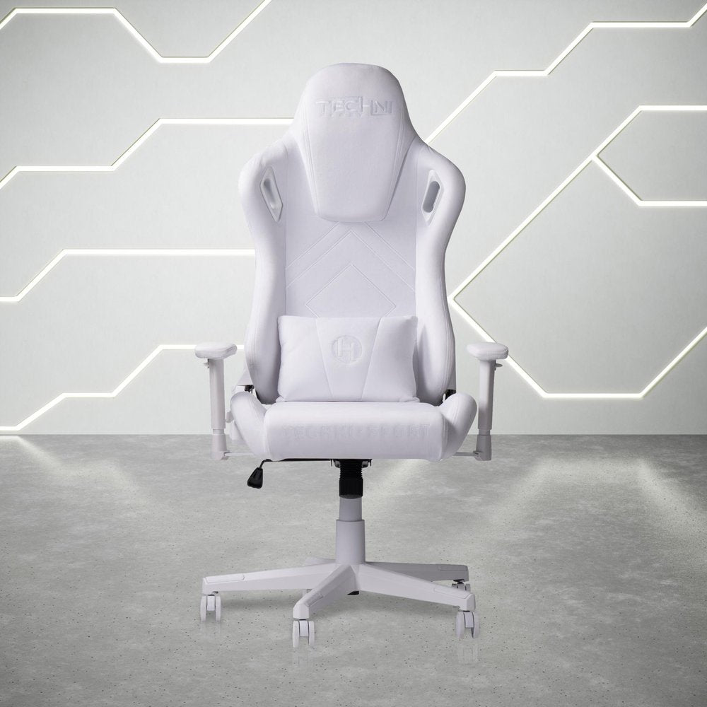White adjustable height swivel rolling gaming chair with lumbar pillow on a concrete floor with a geometric white wall and light accents.