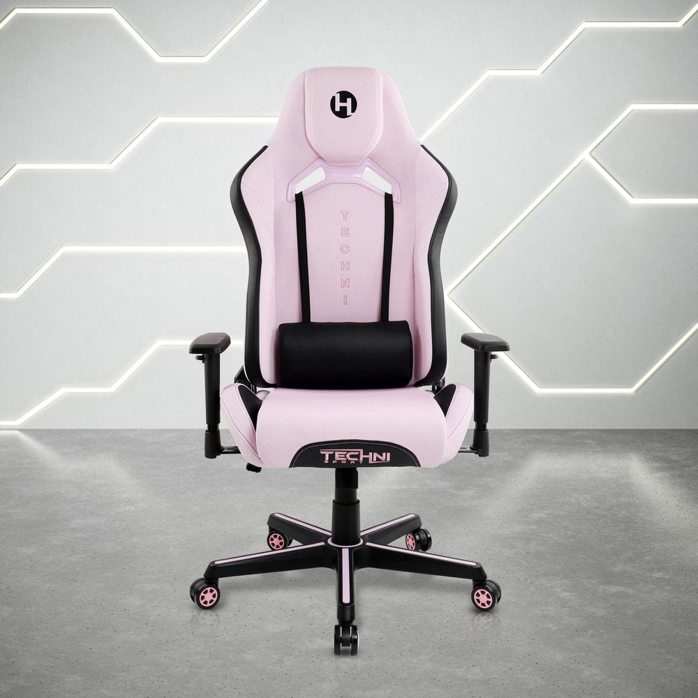 Pink and black gaming chair with adjustable height and swivel rolling base on a concrete floor with a geometric white wall background.