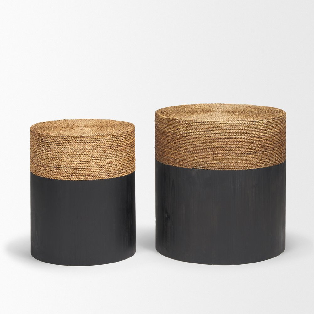 Two round drum-shaped nesting tables, one smaller than the other, with beige woven tops and black solid wood bases on a white background.
