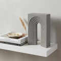 10" Gray Resin Tabletop Sculpture styled in a furnished interior with an off-white wall on a wood floor.