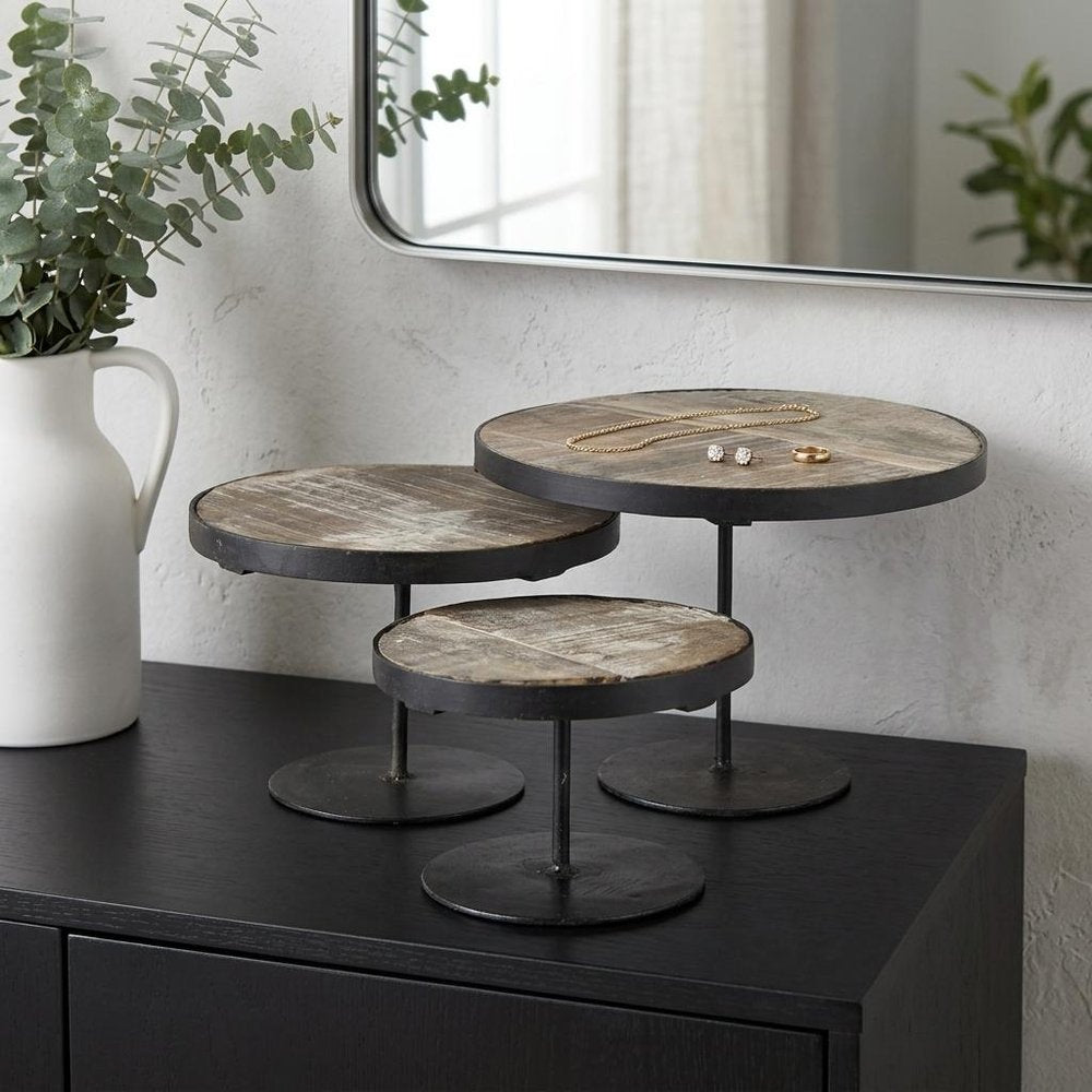 Set of Three Black And Light Brown Iron And Solid Wood Round Risers in a home interior