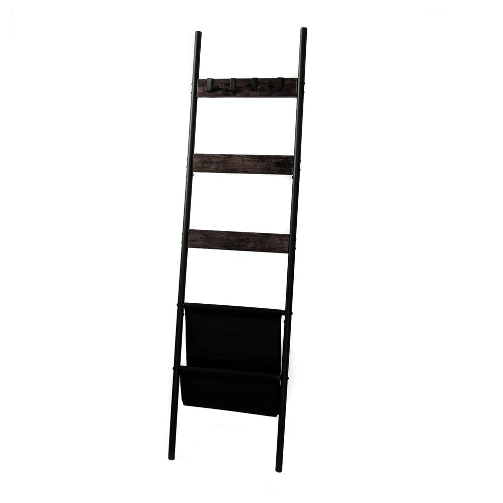 Black metal blanket ladder with wooden rungs and a black fabric magazine holder, shown against a white background.