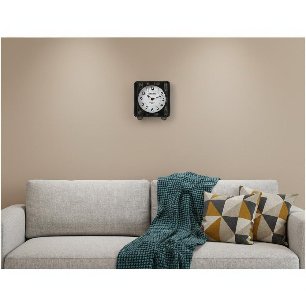 6" Black Metal Analog Round Wall Clock. Wall clock isolated on a plain white background, showing a metal surface.