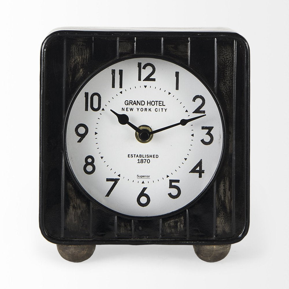 6" Black Metal Analog Round Wall Clock. Wall clock isolated on a plain white background, finished in black metal.