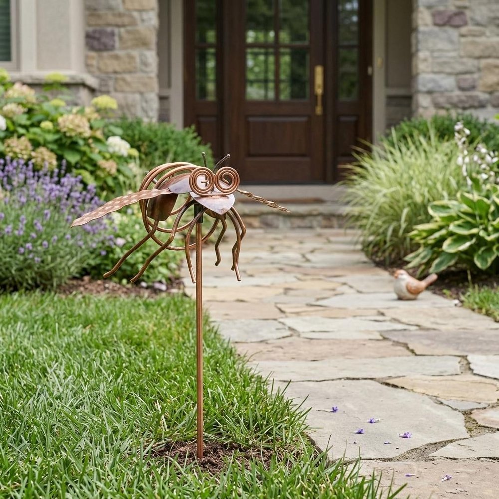 3" Copper Insect Garden Stake shown outdoors on a patio with greenery in green.