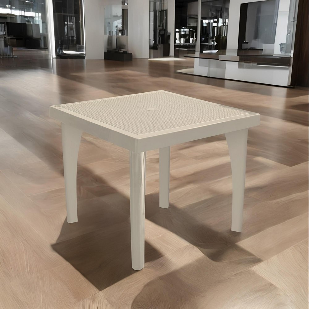 A taupe plastic square outdoor dining table with an umbrella hole sits on a light wood floor in a showroom.
