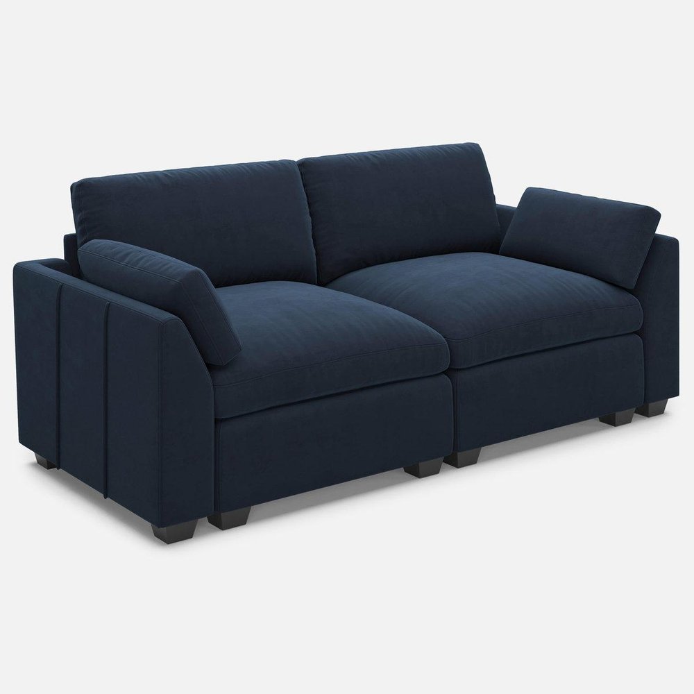 Navy blue velvet modular loveseat with black legs on a white background.