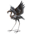 Copper and silver metal flamingo garden accent with wings spread, on a white background.