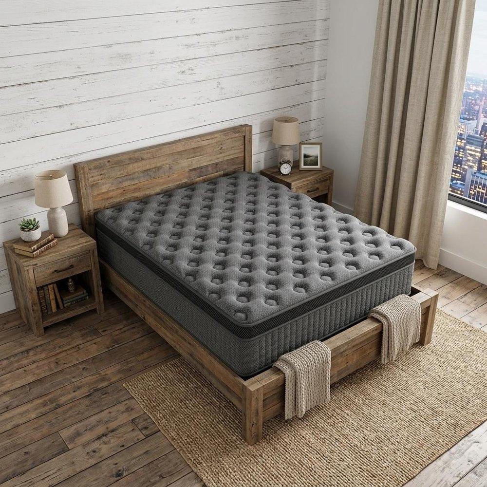 14" Twin Lumbar Support Memory Foam Hybrid Mattress styled in a furnished interior with an off-white wall on a dark wood floor.