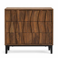 Walnut wood three-drawer nightstand with ribbed texture on a white background.