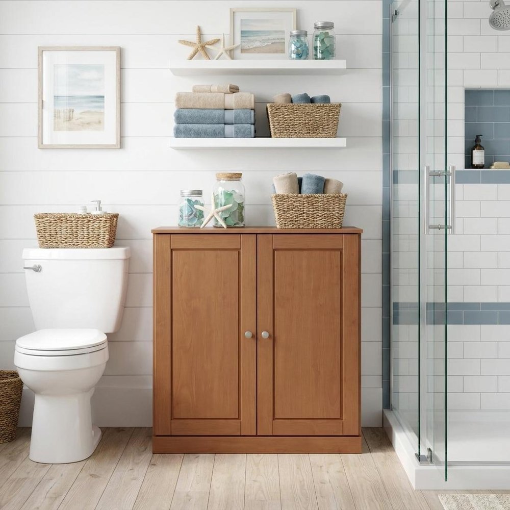 32" White Solid Wood Raised Panel Double Door Linen Cabinet. Bathroom storage isolated on a plain white background, showing a white wood surface.