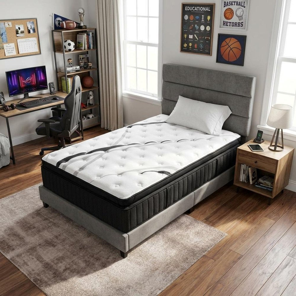 16" Graphite And Titanium Infused Twin Gel Memory Foam Ultra plush Hybrid Mattress styled in a furnished interior with a light gray wall on a wood floor.