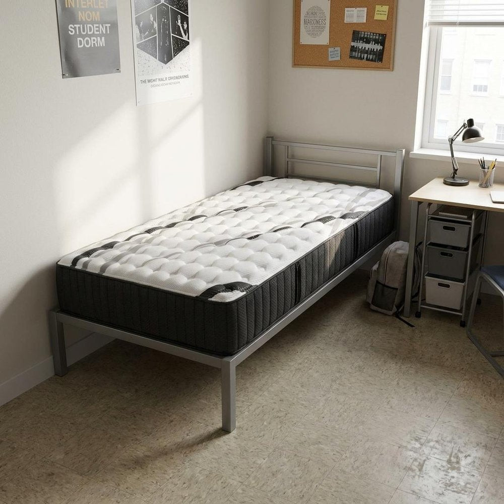 14" Graphite And Titanium Infused Twin Gel Memory Foam Medium Hybrid Mattress styled in a furnished interior with a light gray wall on a wood floor.