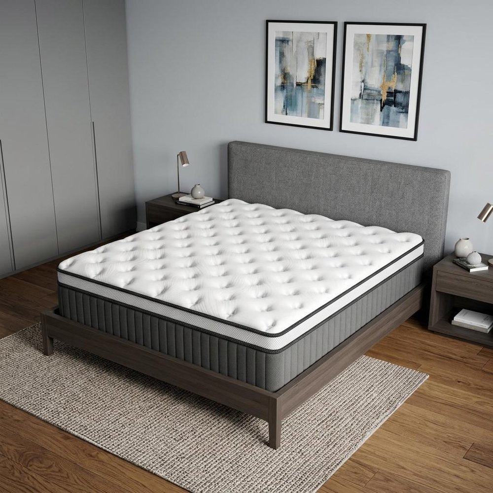 14" Twin Memory Foam Medium Euro Top Hybrid Mattress styled in a furnished interior with a gray wall on a wood floor.