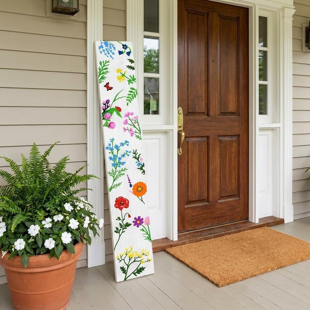 47" White Blue And Green Solid Wood Floral Bouquet Porch Sign shown outdoors on a patio with greenery.