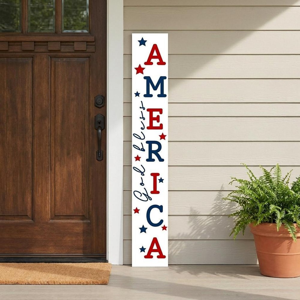 59" Red White And Blue Solid Wood God Bless America Porch Sign styled in a furnished interior with a tan wall on a wood floor.