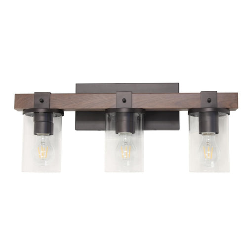 Brown wood and metal three-light bath vanity light with clear glass shades against a white background.