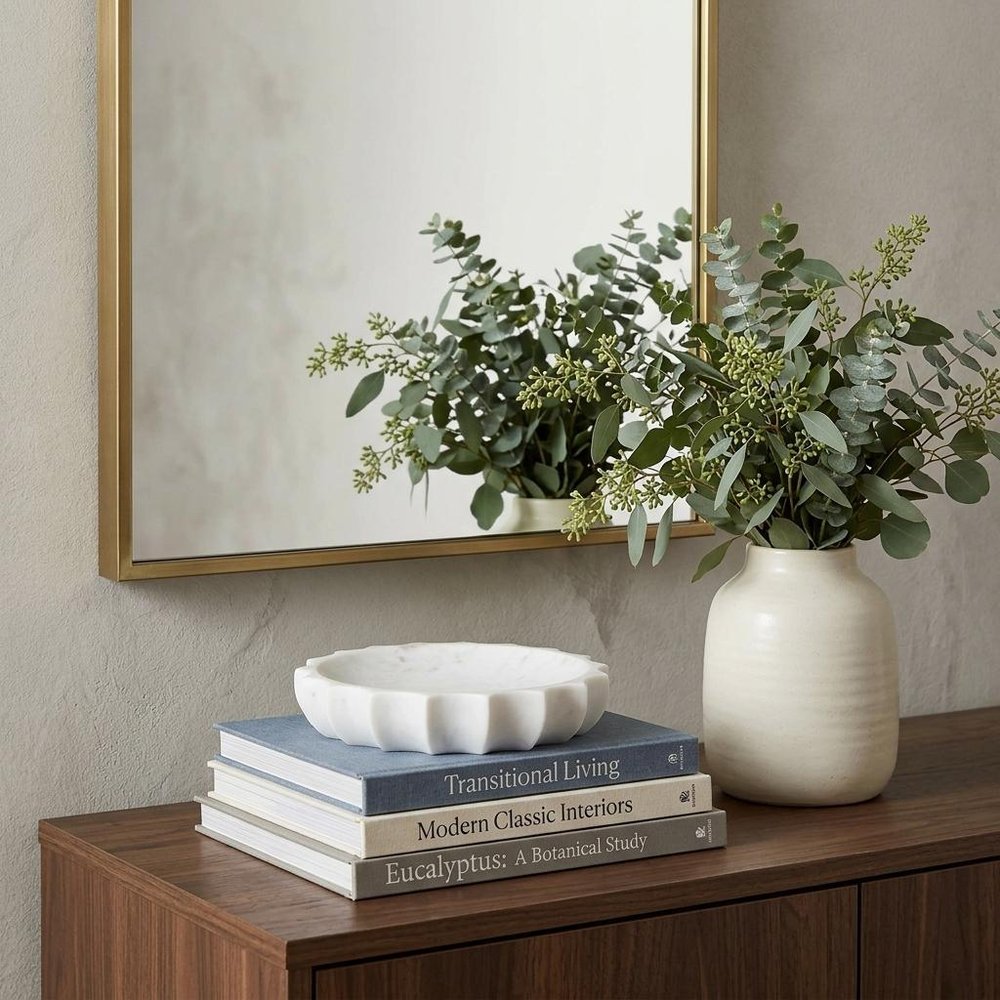 2" Cream Marble Decorative Bowl styled in a furnished interior with an off-white wall on a dark wood floor.
