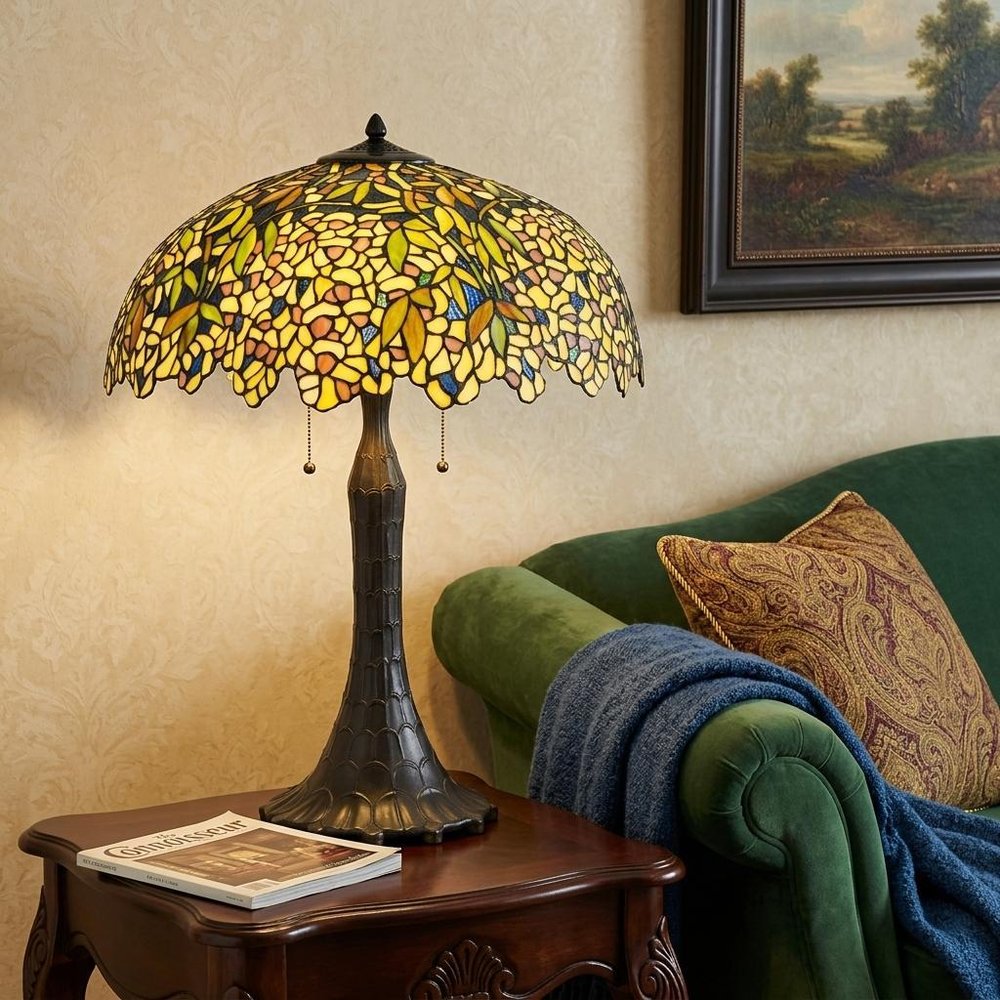 29" Bronze Abstract Two Light Round Tiffany Lamp With Dome Shade styled in a furnished interior with a tan wall on a black floor.