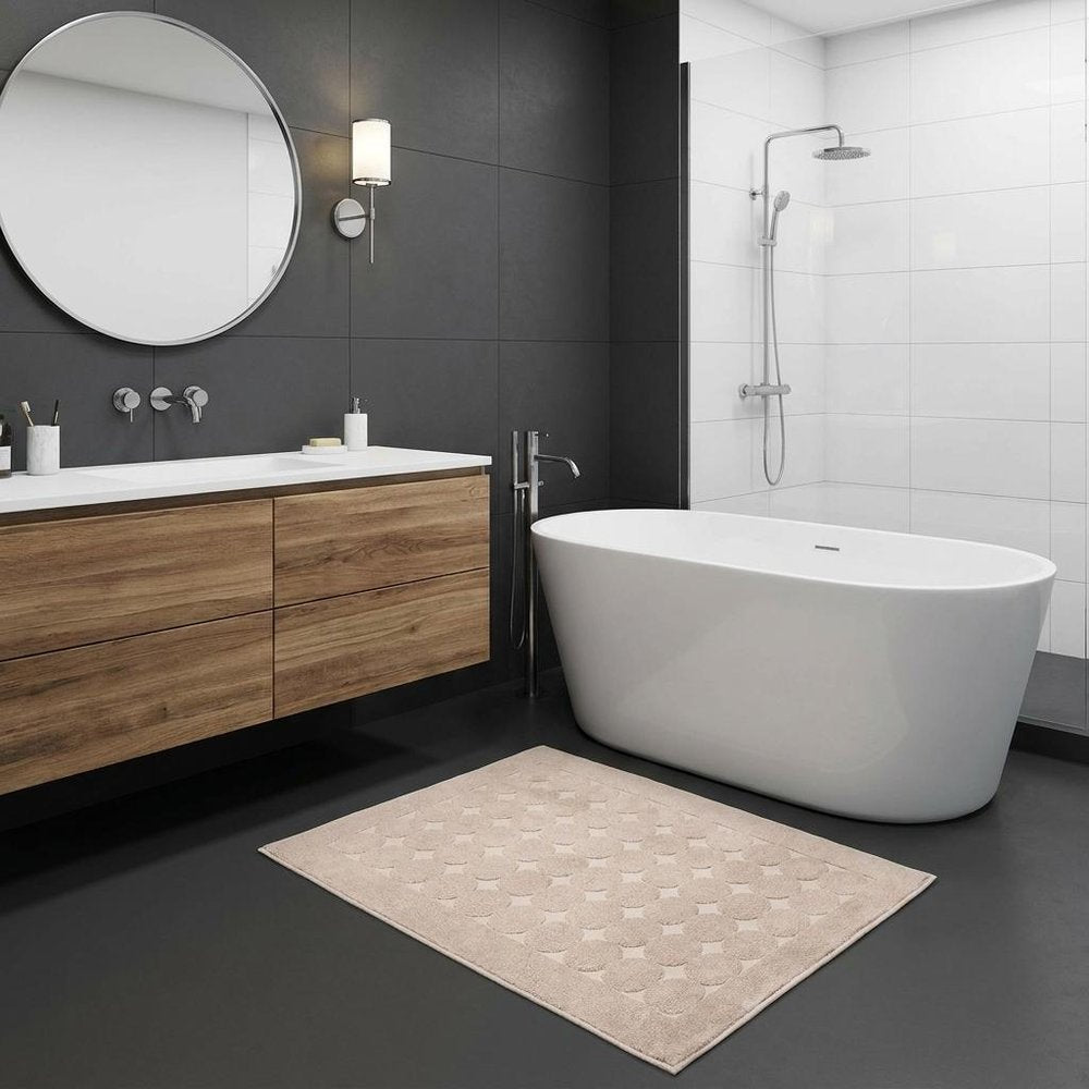 24" X 35" White Tone on Tone Polka Dot Turkish Cotton Bath Rug laid on a charcoal floor in a furnished interior.