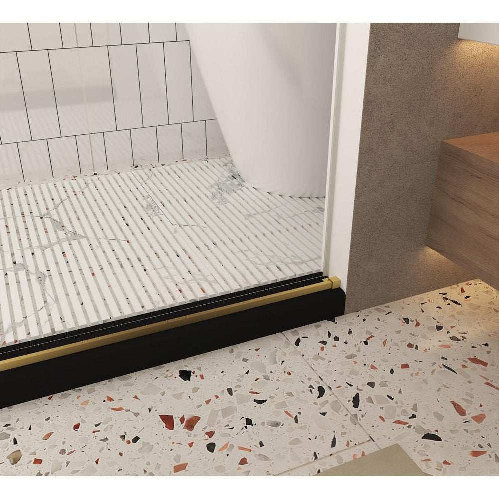 Black and gold aluminum and tempered glass shower door with a slatted white shower base and terrazzo flooring.